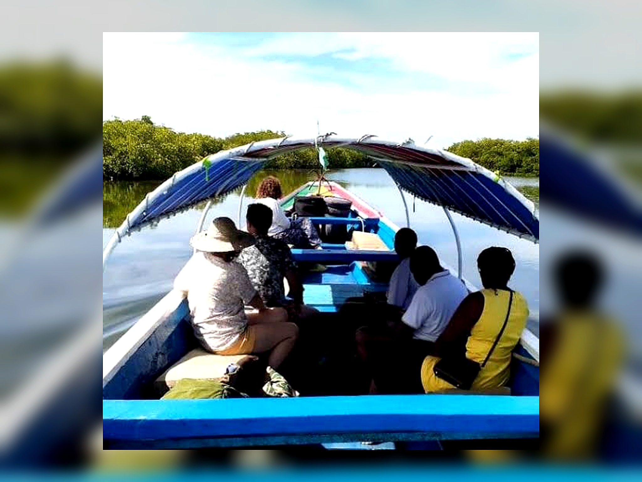 Visitors taking a pirogue ride through the mangroves of Somone Lagoon