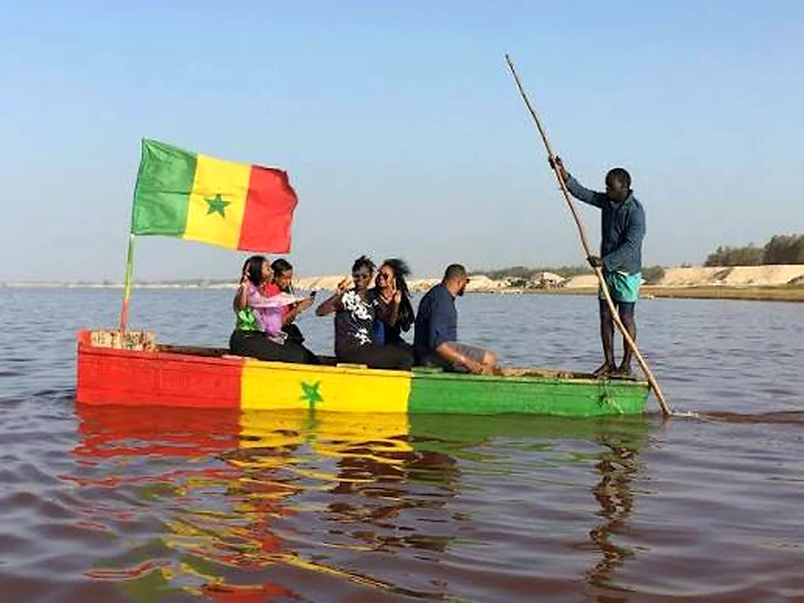 Travellers aboard a traditional pirogue on Lake Retba in Senegal
