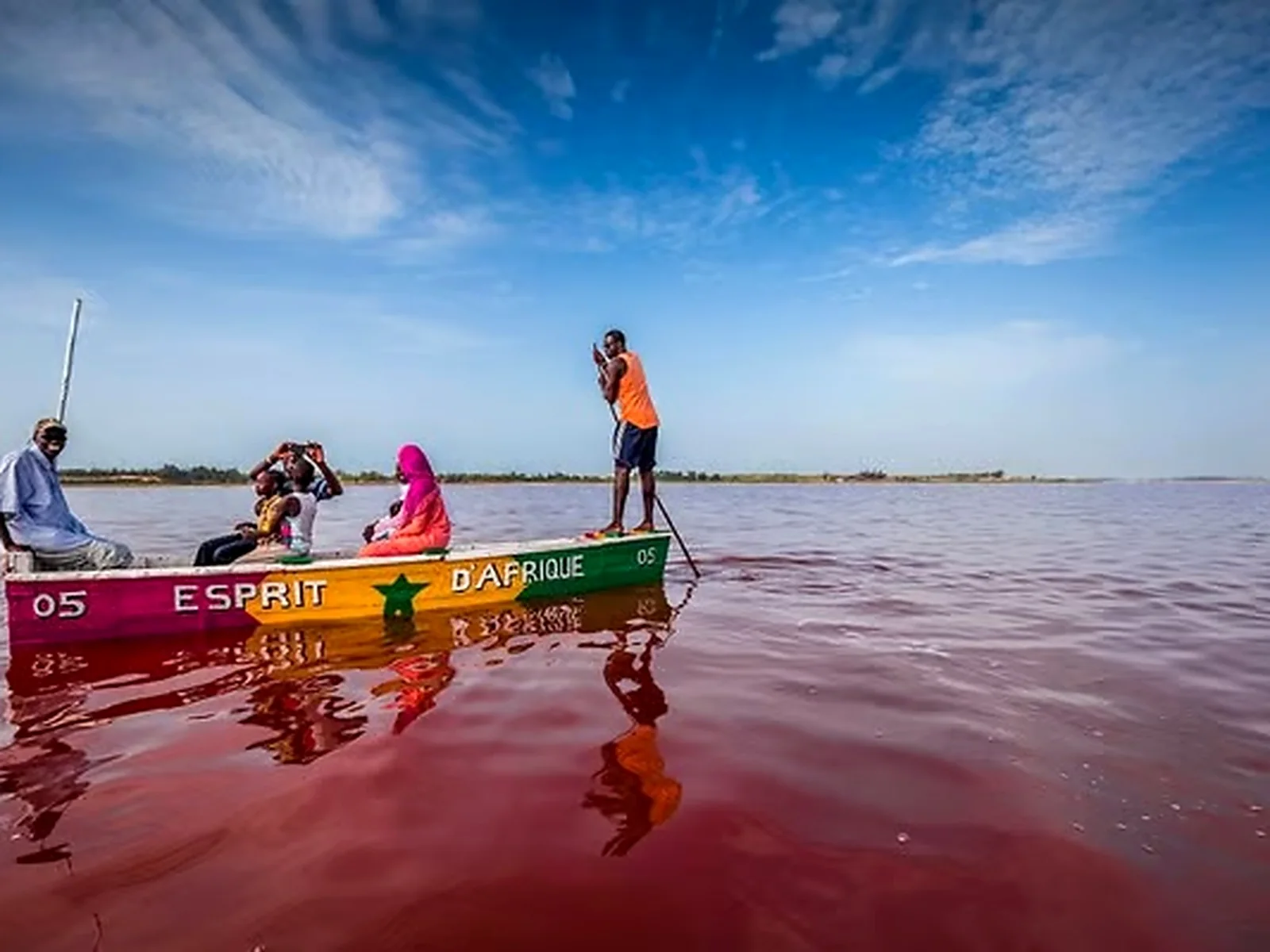 Colourful traditional pirogue sailing on the waters of Lake Retba