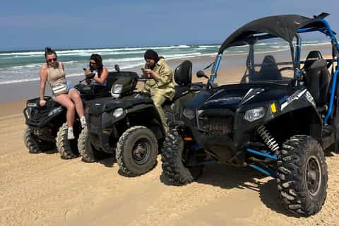 Buggy et quads alignés sur le sable face à l’océan près du Lac Rose